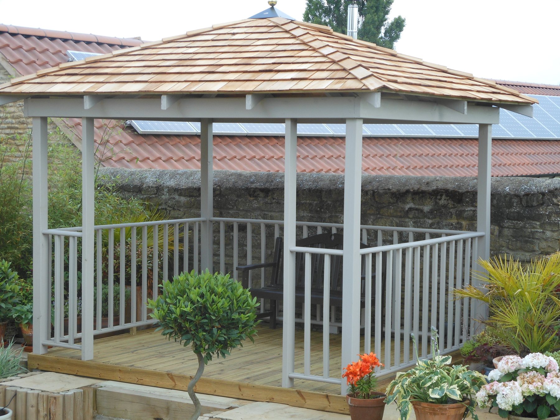 Painted gazebo with balustrade on a deck, cedar shingle roof