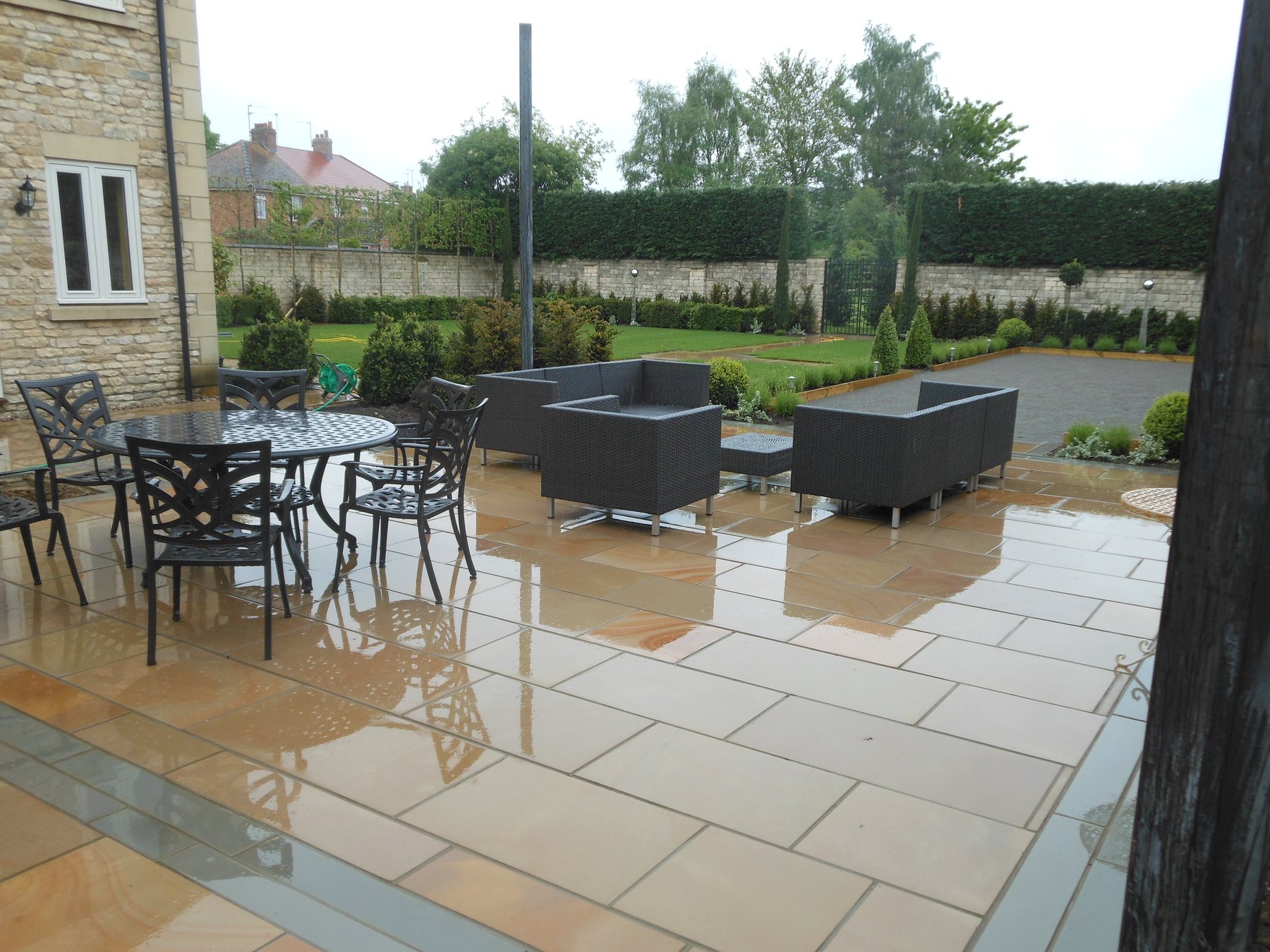 Sandstone terrace with a dining set and outdoor sofas