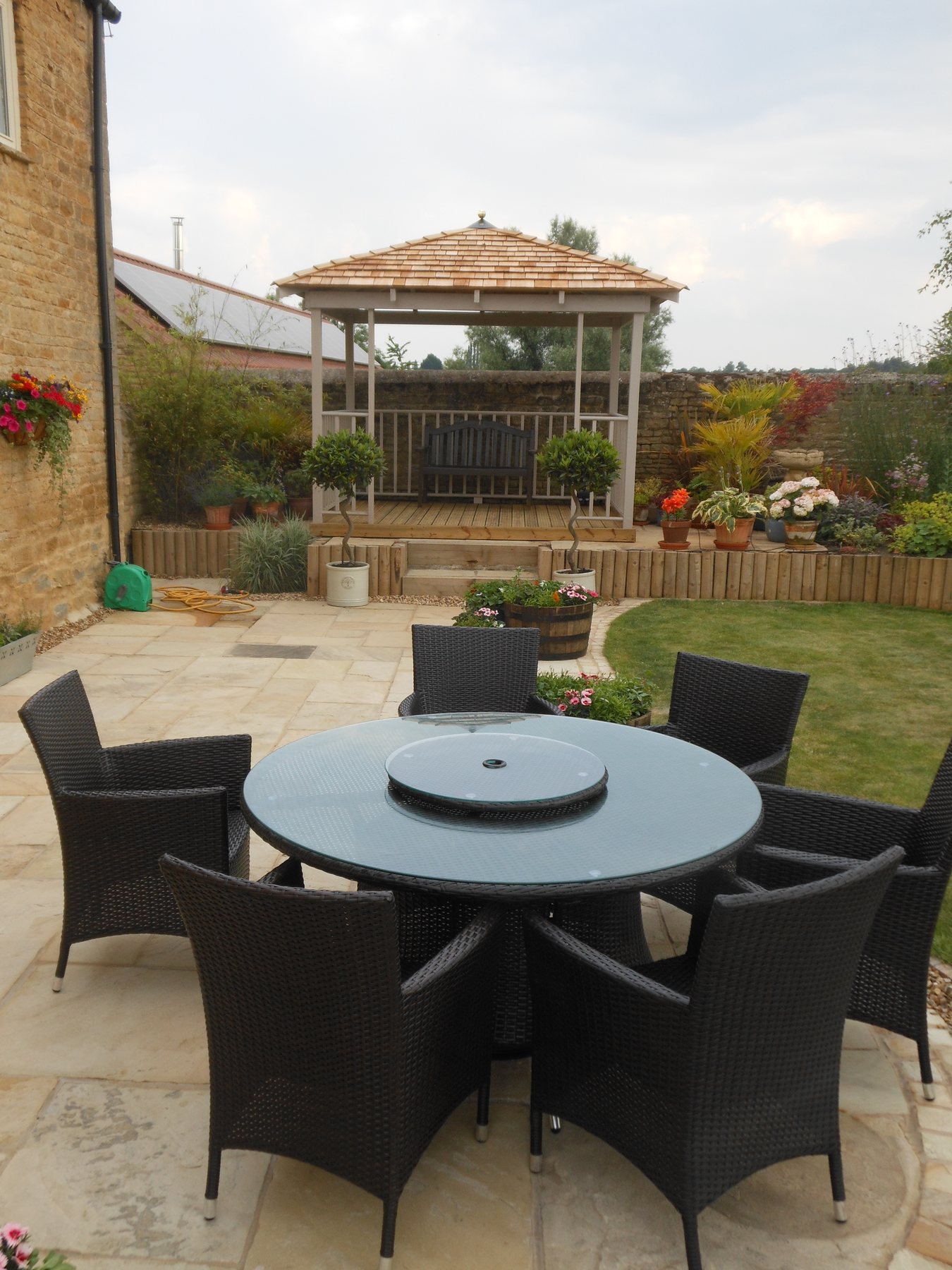 Round dining terrace with a gazebo behind