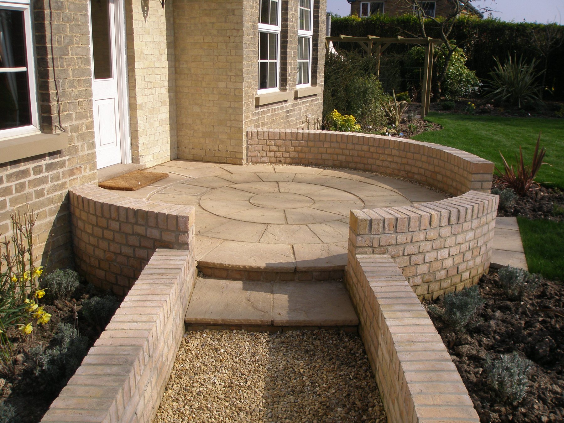 Circular step-up patio with curved brick walls