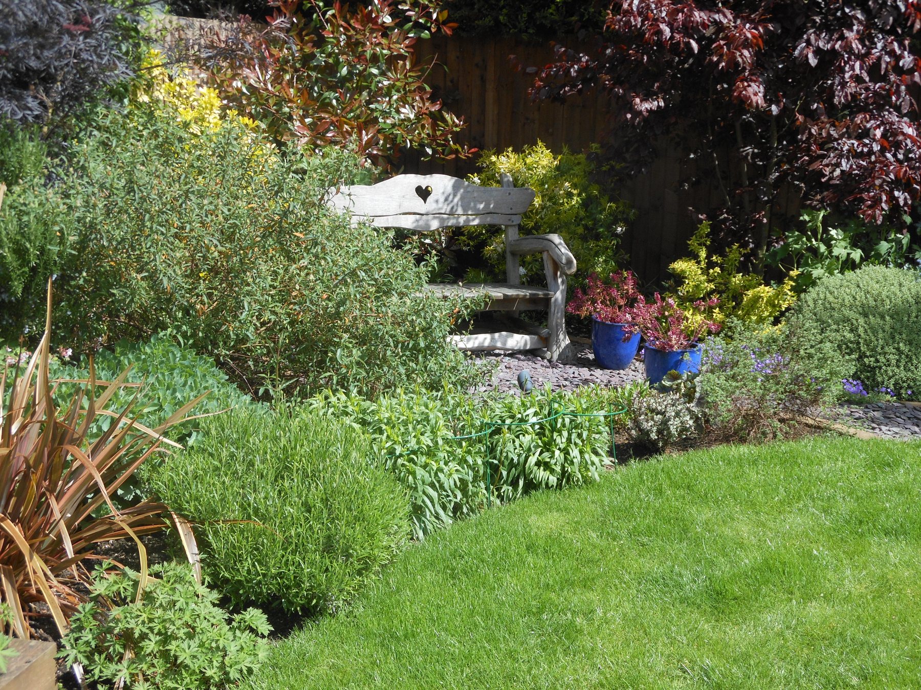 Lush mixed borders curving around a lawn