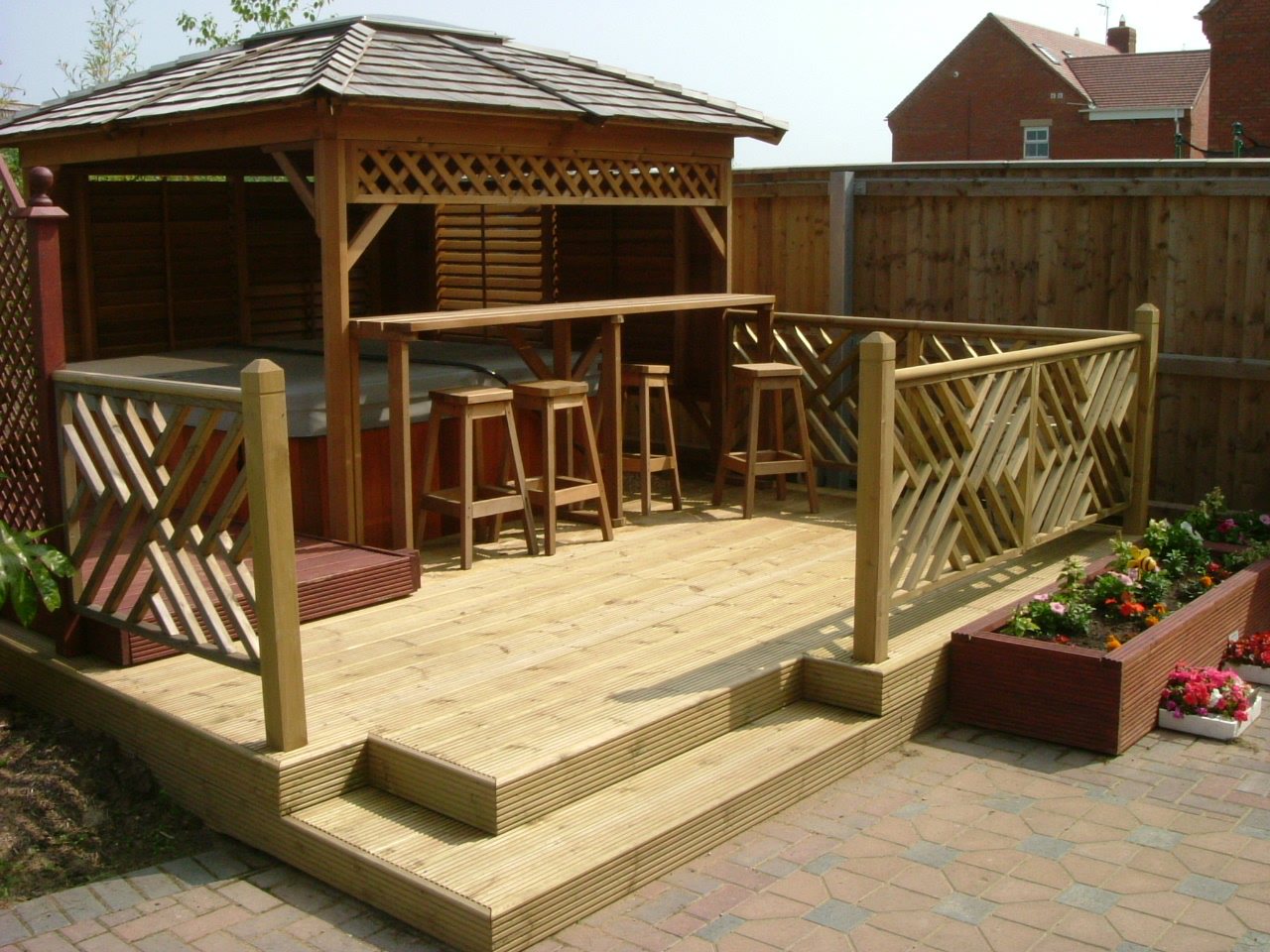 Raised deck with a bar and stools under a timber roof